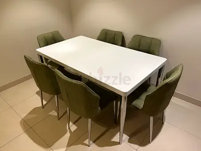 Modern white dining table with 6 olive-green chairs - great condition