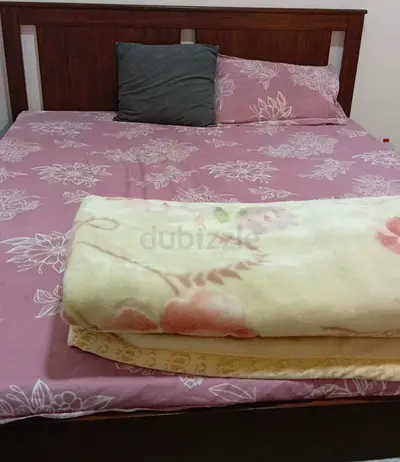 Queen wooden bed frame with mattress and bedding