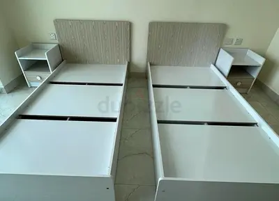 Pair of single beds with matching bedside tables - clean modern design