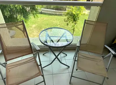 Outdoor balcony set — 2 folding mesh chairs + glass-top side table