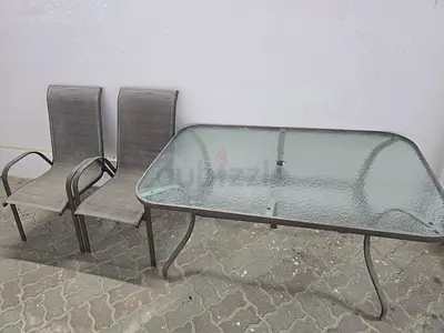Glass-top outdoor dining table with 2 sling chairs - used
