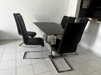Modern black glass dining table with 6 leather cantilever chairs