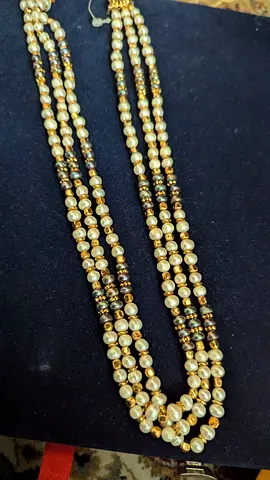 Three-strand faux pearl and black bead necklace