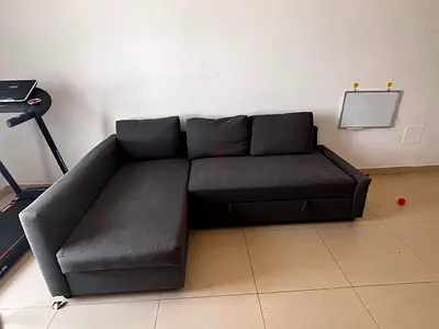 L-shaped grey fabric sofa cum bed