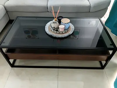 Modern glass-top coffee table with wooden drawer and metal frame