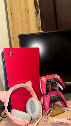 Pink PlayStation 5 with 2 pink controllers and pink kitten headset and tv and black desk