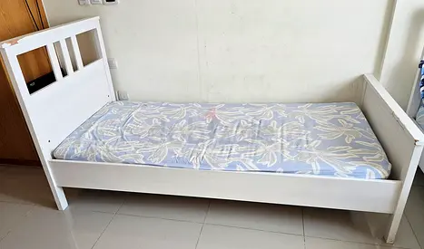 Single white wooden bed frame with mattress