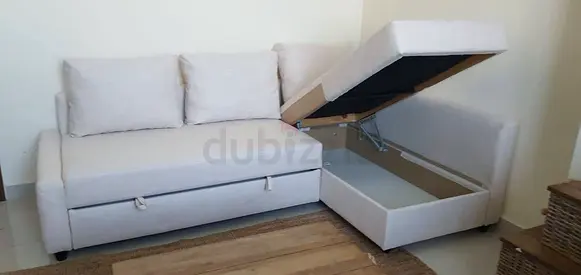 Light beige L-shaped storage sofa bed with cushions - good condition