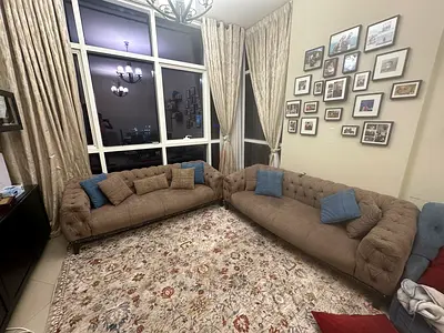 Pair of tufted brown fabric sofas in good condition