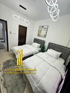 Furnished two-bedroom apartment for monthly rent in Ajman, including utilities, internet, and parkin