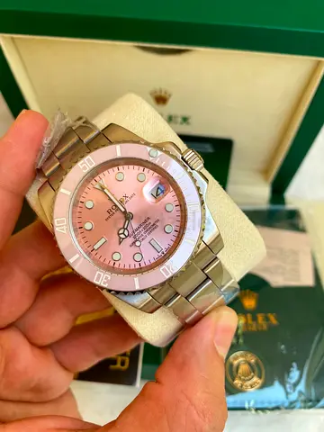 This is a stylized Rolex Submariner featuring a custom pink dial and bezel.