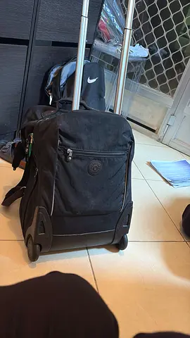 Black rolling backpack with telescopic handle and wheels - good condition