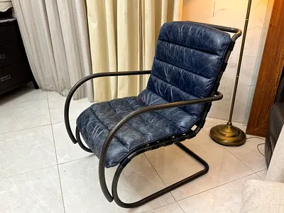 Navy Blue genuine leather rocking chair with a bent metal frame