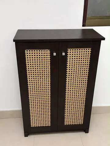 Dark wood cabinet with woven cane doors - compact storage unit