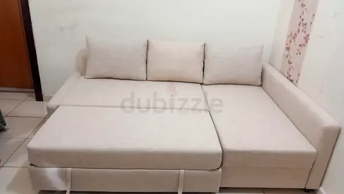 Beige L-Shaped Sofa Bed with Pull-Out Section