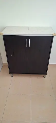 Small dark wood cabinet with marble top