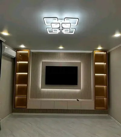 Modern built-in entertainment wall unit with LED shelving and TV frame