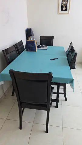 Dark wood 6-seater dining table with padded chairs - good condition