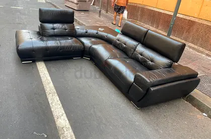 Black leather L-shaped sectional sofa with adjustable headrests - good condition