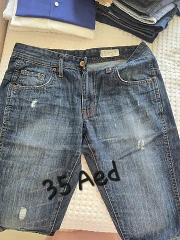 Men's blue distressed jeans - size likely M/L, lightly worn - 35 AED
