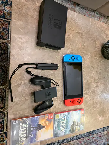 Nintendo Switch console with Joy-Cons, Charger, dock, grip with both Zelda games