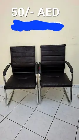Pair of black leather office visitor chairs with chrome frame - AED 50 each
