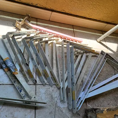 Lot of metal folding shelf brackets — sturdy used hardware