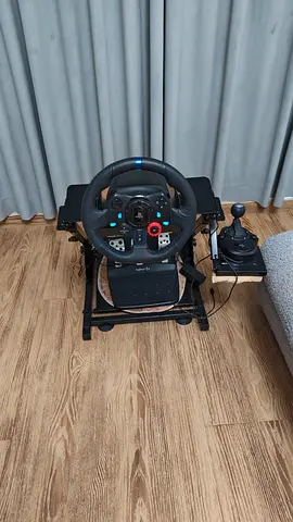 Logitech G29 racing wheel with pedal set and shifter on stand -