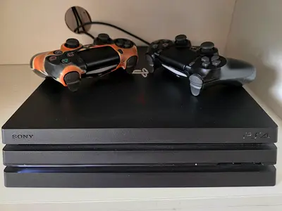 Sony PlayStation 4 Pro Console with Two Wireless Controllers + 1 Game
