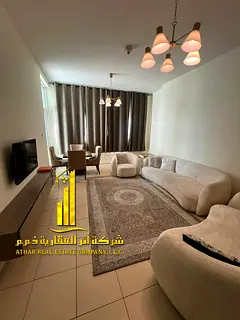 Furnished two-bedroom apartment for monthly rent in Ajman, including utilities, internet, and parkin