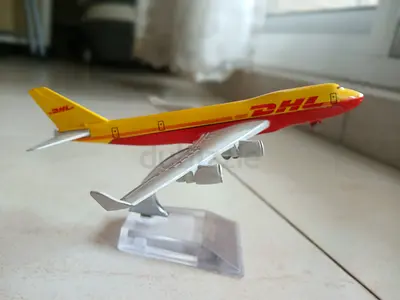 DHL die-cast cargo airplane model on stand