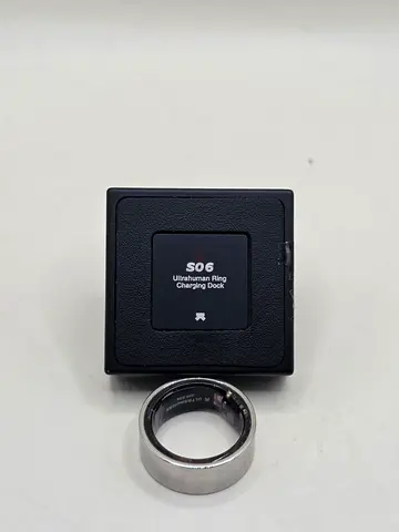 Ultrahuman Ring AIR smart ring and its charging dock. Negotiable