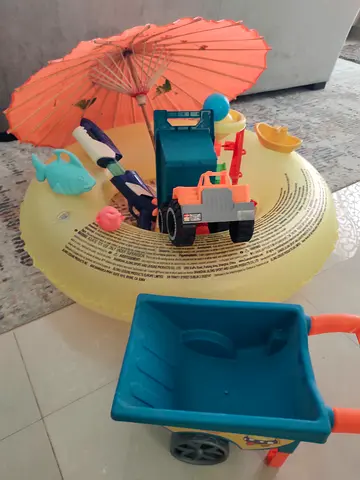 Kids toy set with wheelbarrow, inflatable ring and small vehicles - used