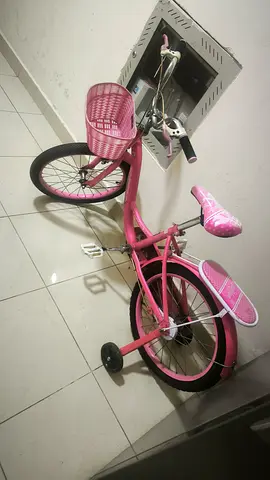 Pink girls' kids bicycle with training wheels and basket - good condition