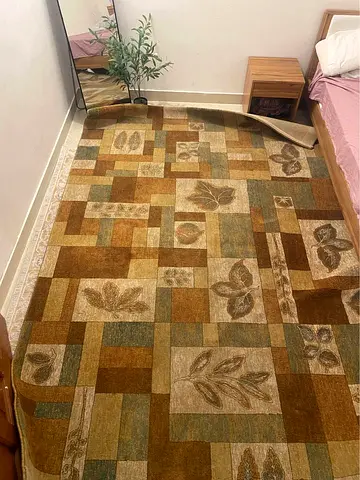 Used rectangular floral patchwork rug - earthy tones, good condition