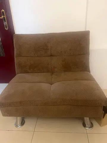 Single beige upholstered accent chair in good used condition