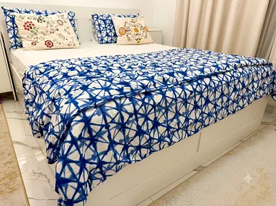 White storage bed with blue patterned bedspread - good condition