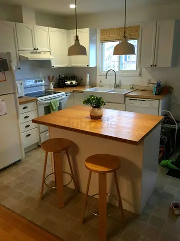 Small kitchen island with butcher block top storage