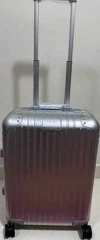 Silver hard-shell carry-on suitcase