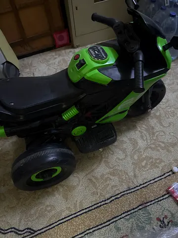 Green electric ride-on quad for toddlers - working condition