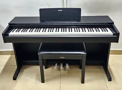 The Yamaha Arius YDP-103B is an 88-key, entry-level digital console piano featuring a black finish,