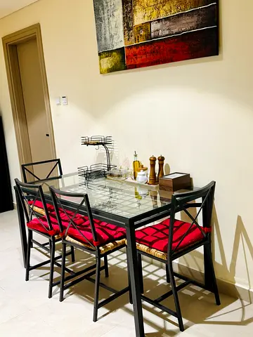 Modern Glass Top Dining Table with 4 Chairs and Red Cushions