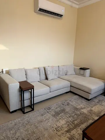 Light grey L-shaped sectional sofa in good condition