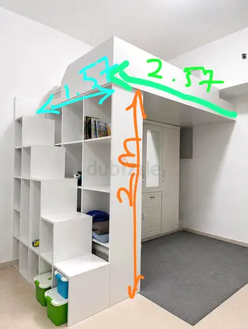 Custom white loft storage unit with shelving and overhead platform