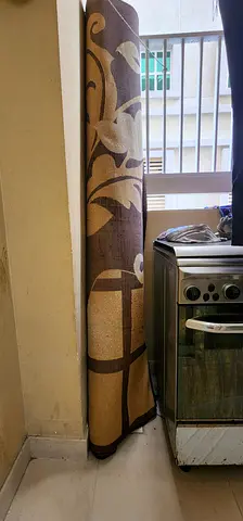 Rolled brown floral area rug - good condition