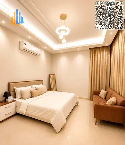 A fully furnished villa in Al Helio 2, Ajman, offering space, privacy, and comfort, with a rooftop and a small garden with an outdoor seating area.