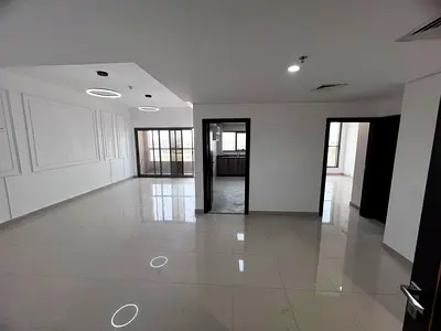 Two bedrooms and a living room, two master bedrooms, three bathrooms, spacious areas, built-in wardrobes, balcony with an open view.