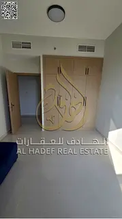 For rent in Ajman: A very spacious apartment featuring three bedrooms, a living room, and four bathr