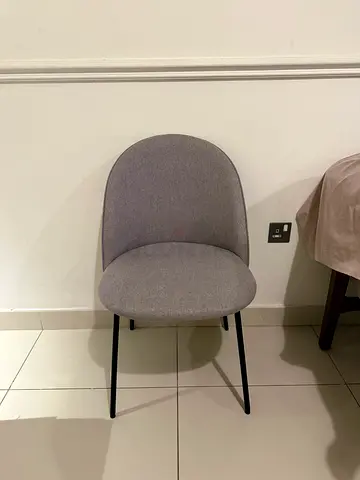 Grey upholstered dining/side chair with slim black legs