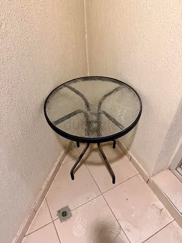 Small round glass-top side table with metal frame